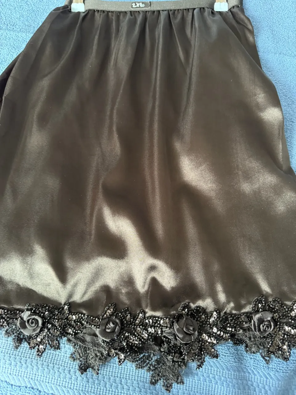 handmade lingerie in breathable black satin with a 3D floral lace and sequin hem.