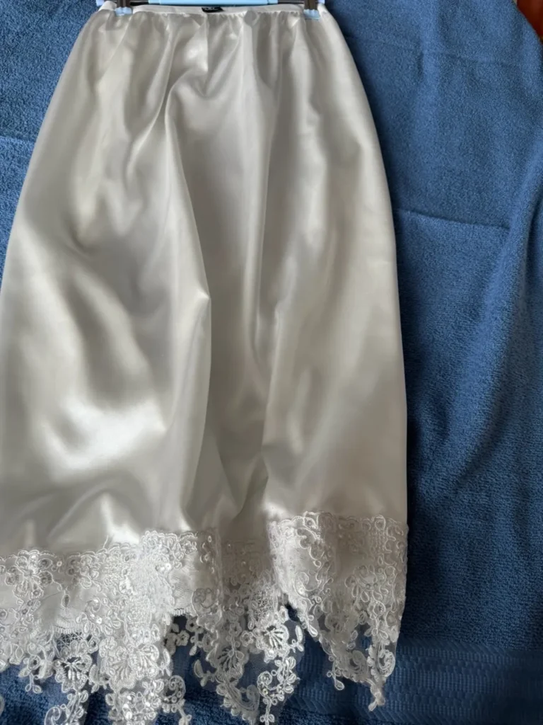 sleepwear for women featuring a breathable white satin skirt with intricate floral lace trim.