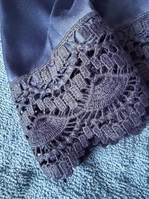 comfortable lingerie featuring breathable navy blue satin and heavy, textured geometric lace.